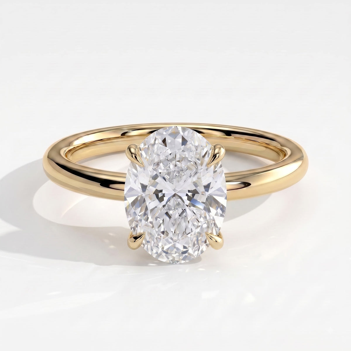 Oval lab-grown diamond solitaire engagement ring in 18K (750) yellow gold, front view 