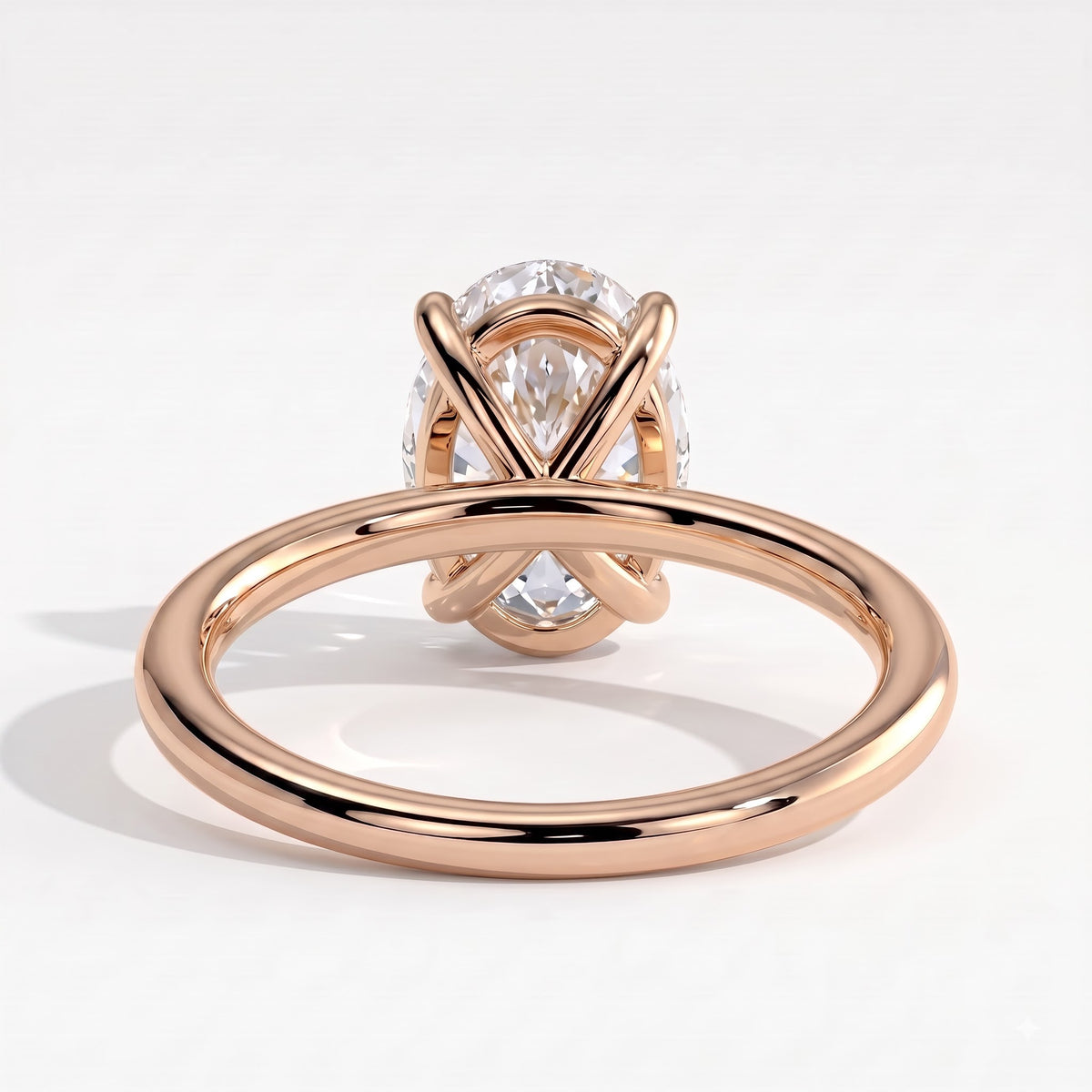 Oval lab-grown diamond solitaire engagement ring in 18K (750) rose gold, on white background 