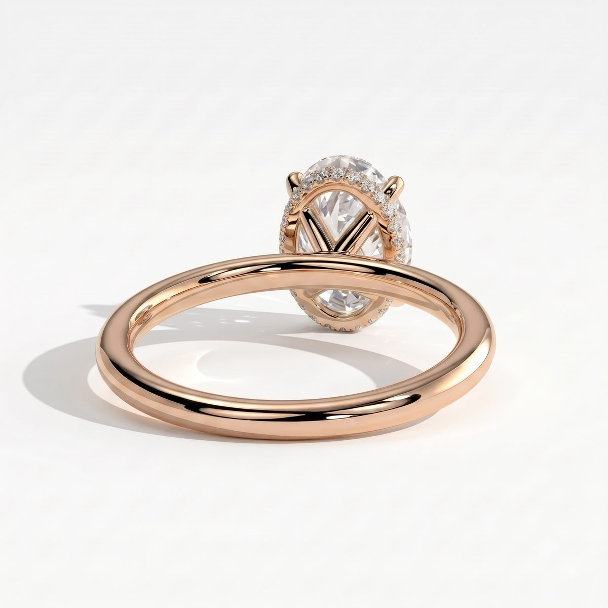 Oval lab-grown diamond solitaire engagement ring in 18K (750) rose gold, on white background 
