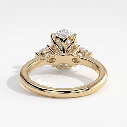 Oval lab-grown diamond three-stone engagement ring in 14K (585) yellow gold, on white background 