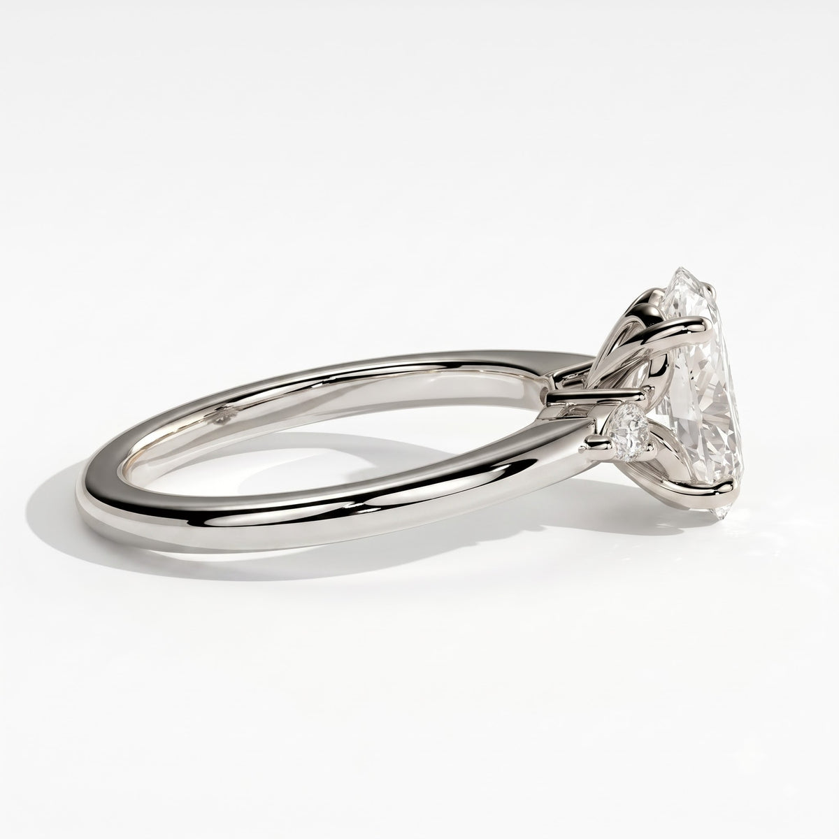 Oval lab-grown diamond three-stone engagement ring in 18K (750) white gold, detail view 