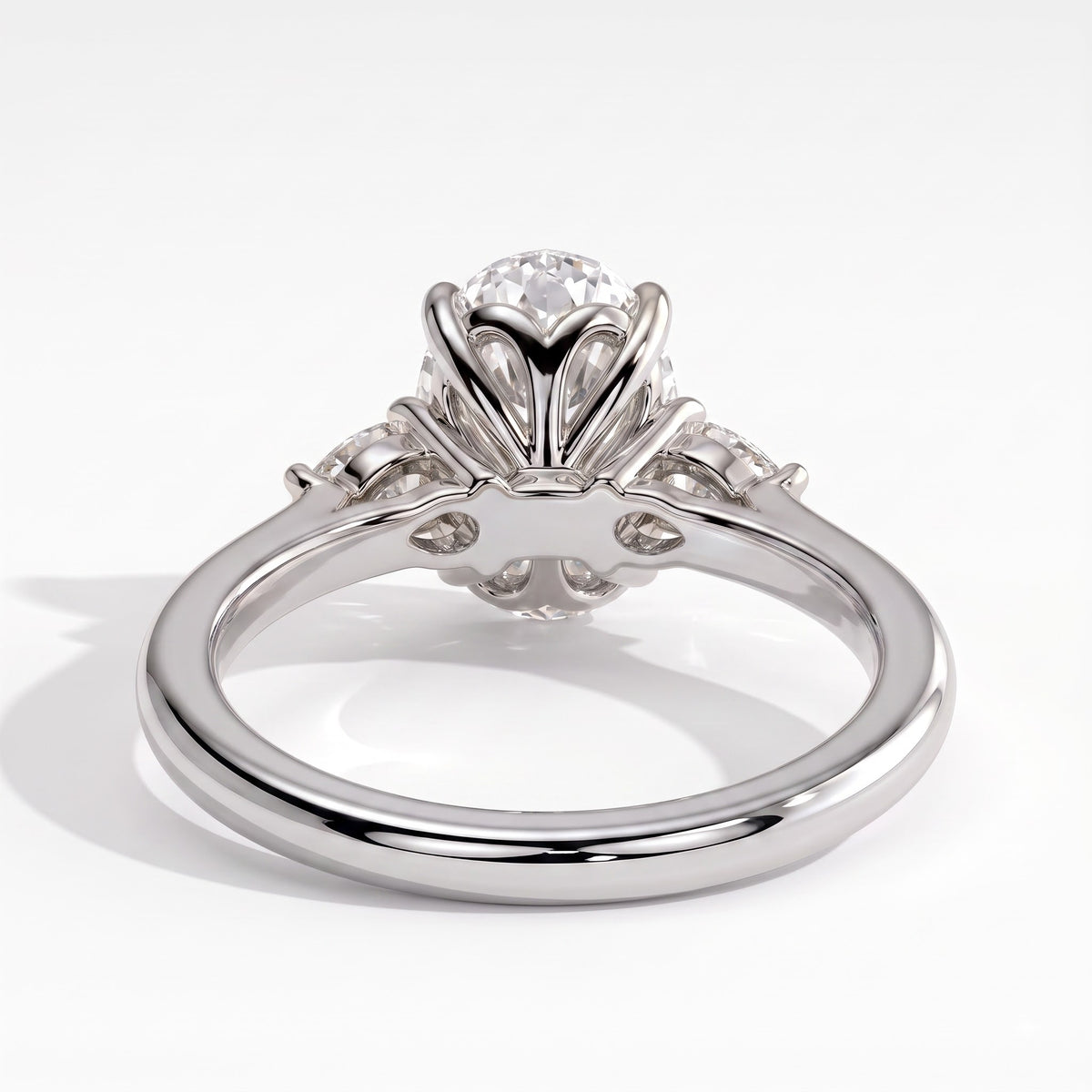 Oval lab-grown diamond three-stone engagement ring in 950 platinum, on white background 