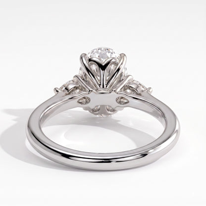 Oval lab-grown diamond three-stone engagement ring in 950 platinum, on white background 