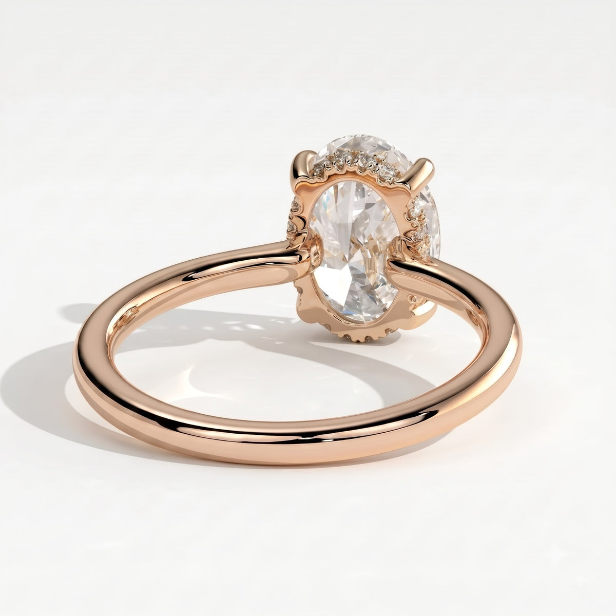 Oval lab-grown diamond solitaire engagement ring in 14K (585) rose gold, on white background 