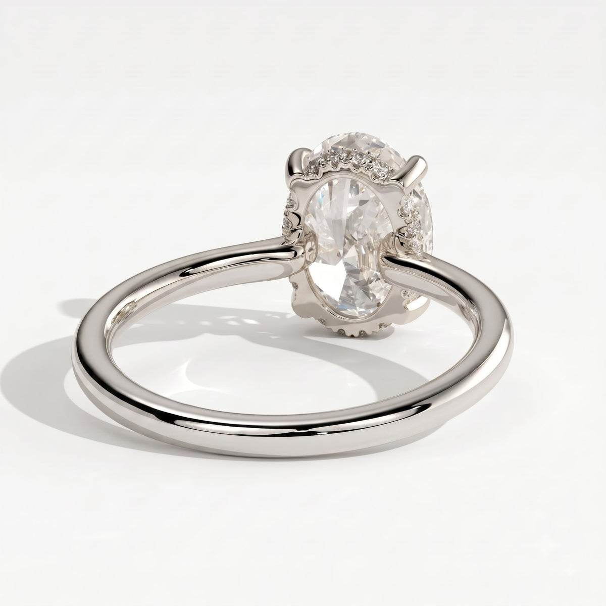 Oval lab-grown diamond solitaire engagement ring in 14K (585) white gold, on white background 