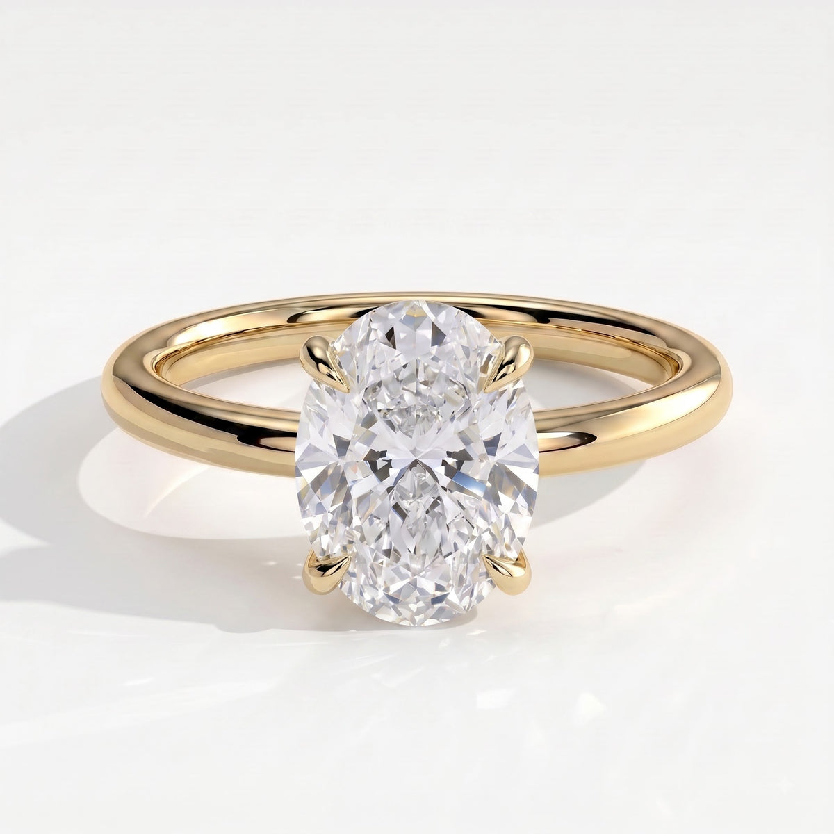 Oval lab-grown diamond solitaire engagement ring in 18K (750) yellow gold, front view 