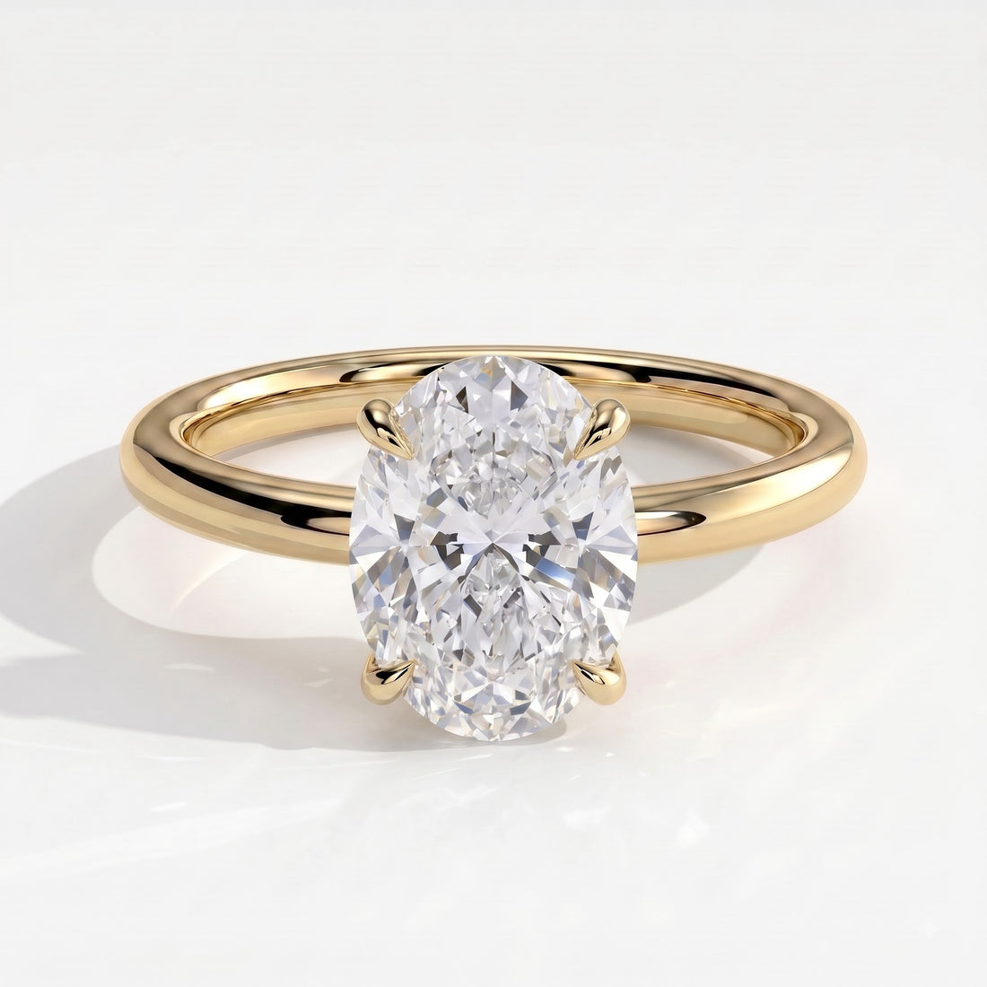 Oval lab-grown diamond solitaire engagement ring in 14K (585) yellow gold, front view 