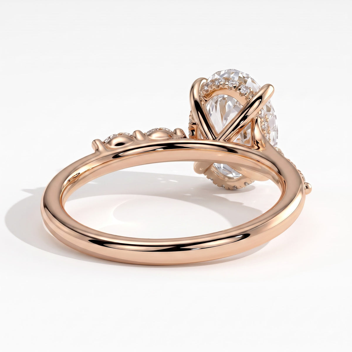 Oval lab-grown diamond halo engagement ring in 14K (585) rose gold, on white background 