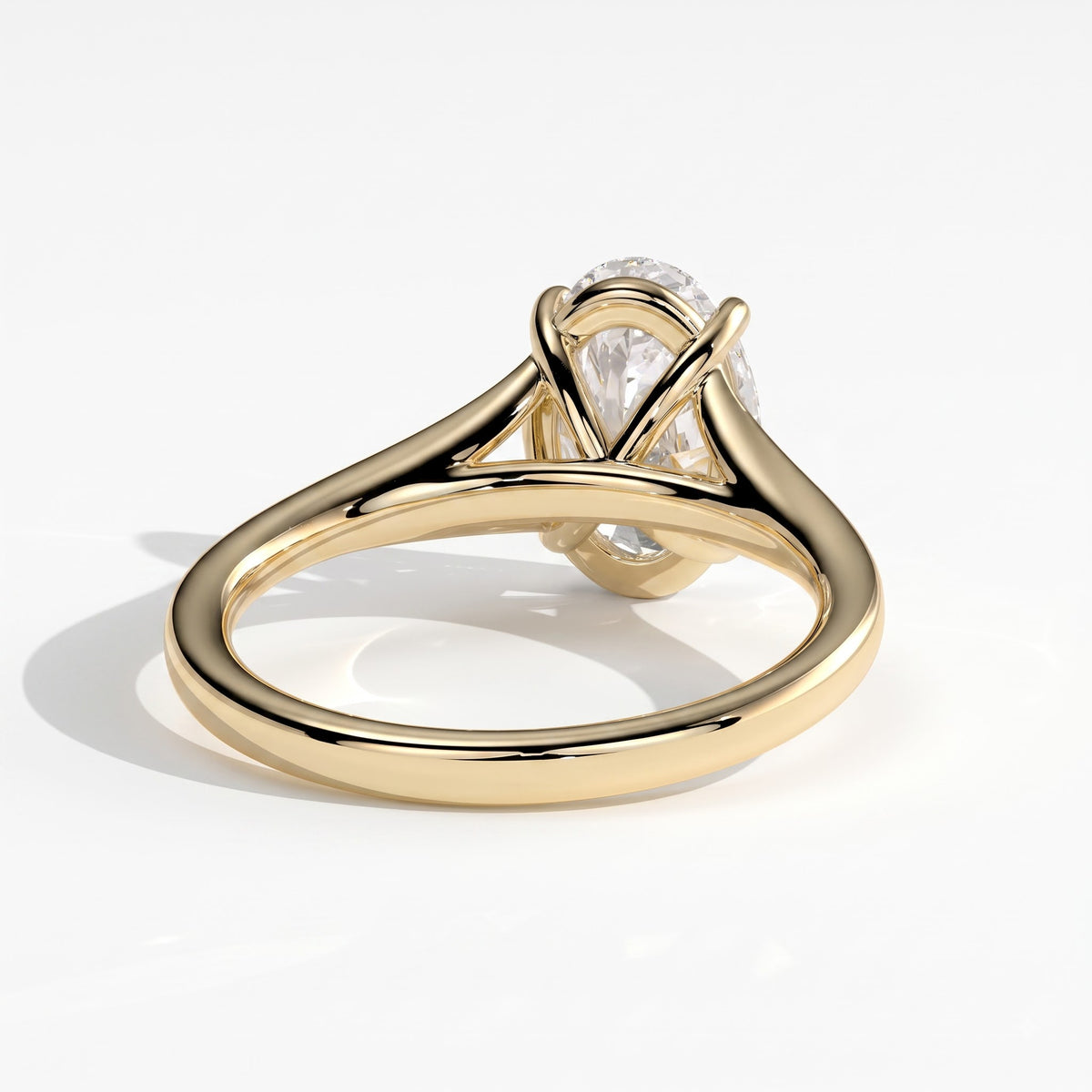 Oval lab-grown diamond solitaire engagement ring in 14K (585) yellow gold, on white background 