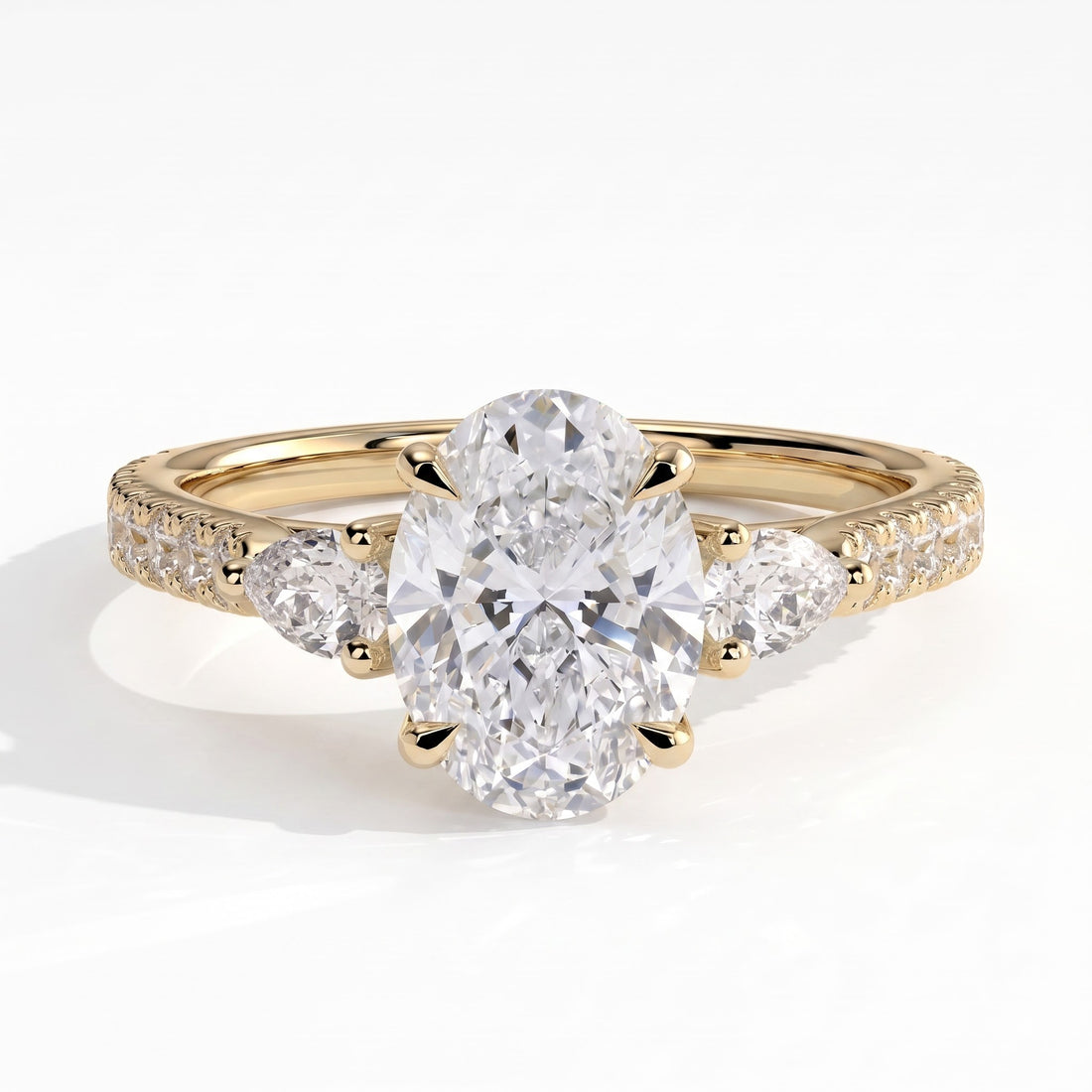 Oval lab-grown diamond three-stone engagement ring in 14K (585) yellow gold, front view 