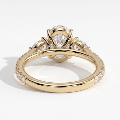 Oval lab-grown diamond three-stone engagement ring in 14K (585) yellow gold, on white background 