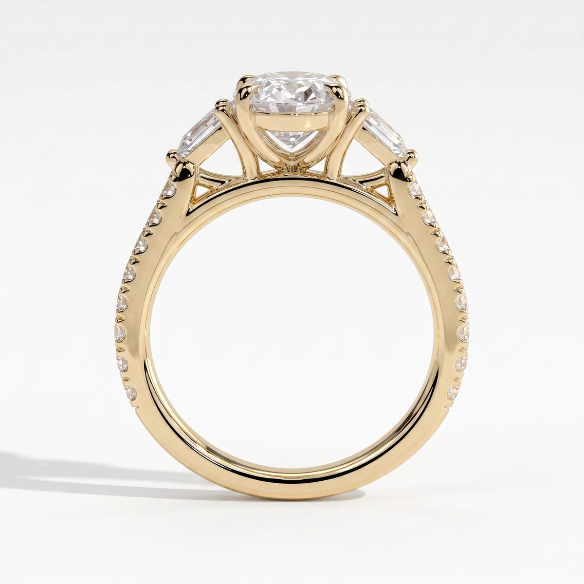 Oval lab-grown diamond three-stone engagement ring in 14K (585) yellow gold, side profile 