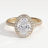 Oval lab-grown diamond halo engagement ring in 14K (585) yellow gold, front view 