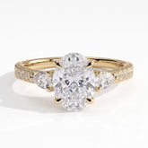 Oval lab-grown diamond three-stone engagement ring in 18K (750) yellow gold, front view 