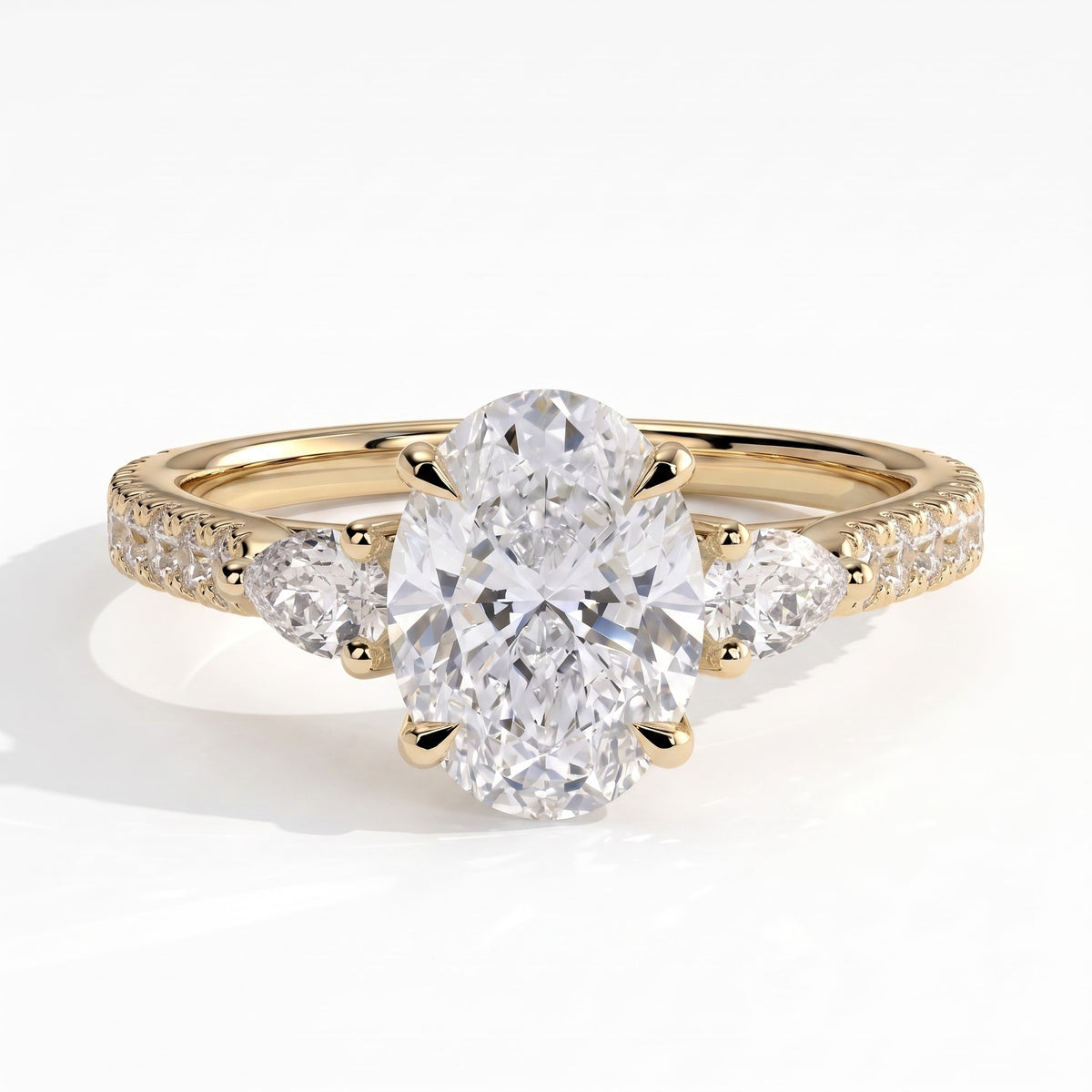 Oval lab-grown diamond three-stone engagement ring in 18K (750) yellow gold, front view 