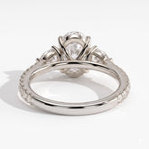 Oval lab-grown diamond three-stone engagement ring in 950 platinum, on white background 