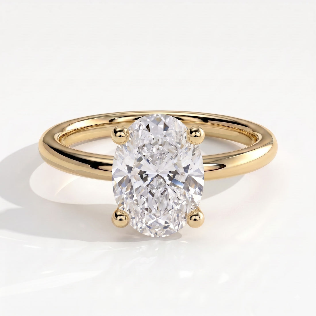Oval lab-grown diamond solitaire engagement ring in 14K (585) yellow gold, front view 
