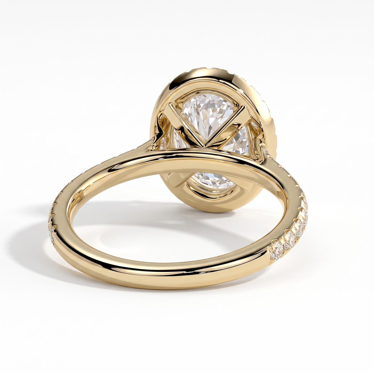 Oval lab-grown diamond halo engagement ring in 18K (750) yellow gold, on white background 