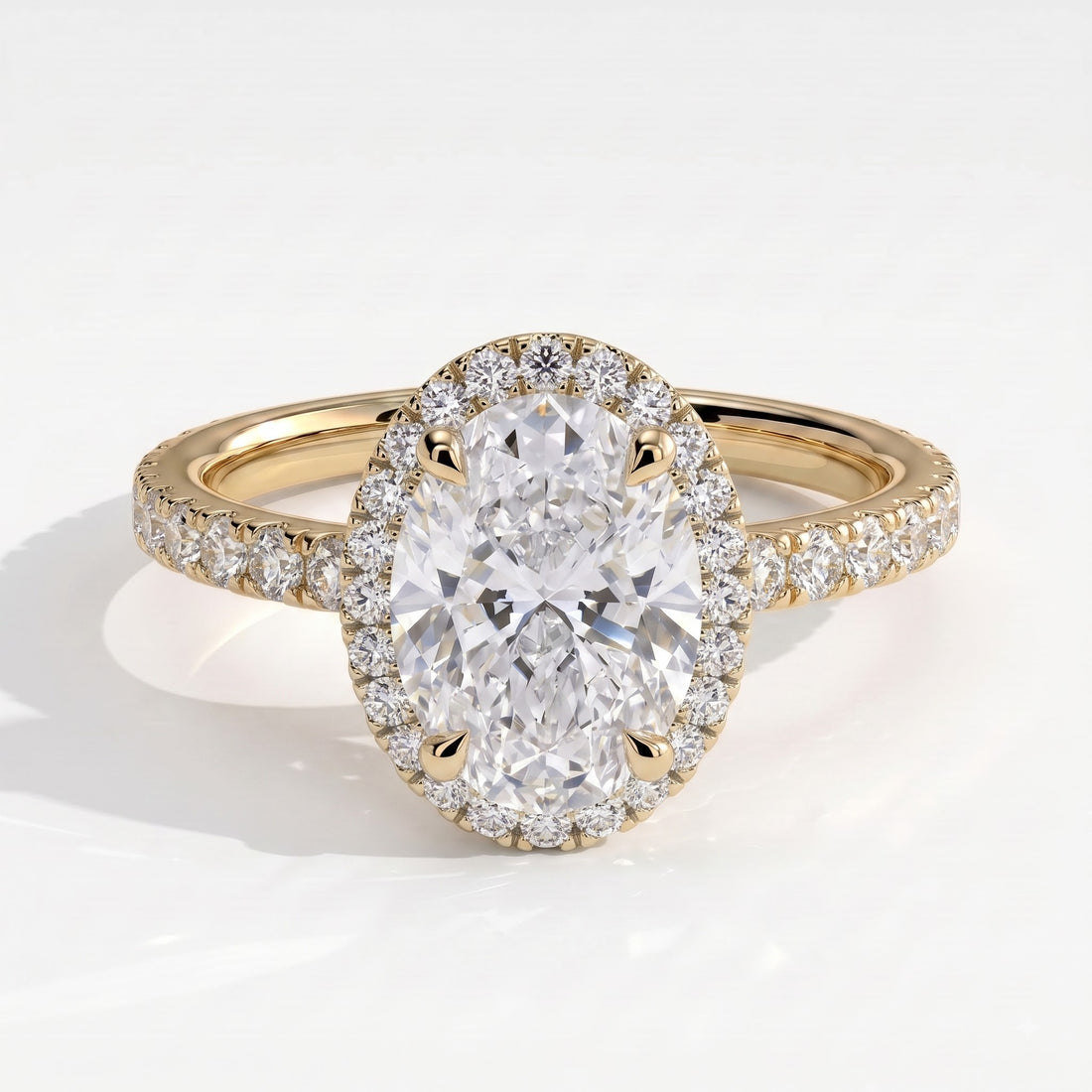 Oval lab-grown diamond halo engagement ring in 14K (585) yellow gold, front view 