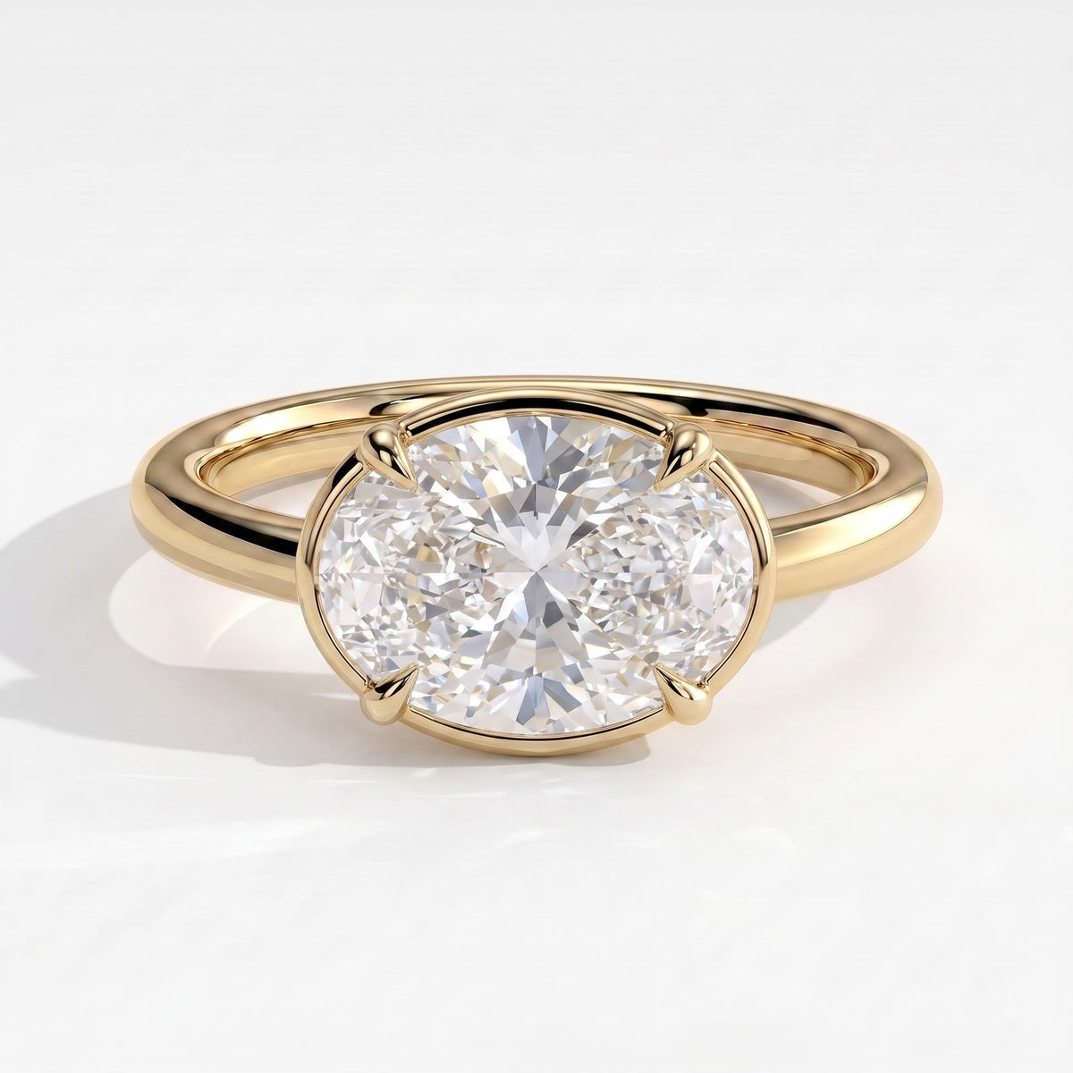 Oval lab-grown diamond bezel-set east-west solitaire engagement ring in 14K (585) yellow gold, front view 
