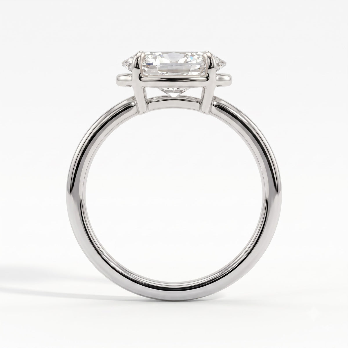 Oval lab-grown diamond bezel-set east-west solitaire engagement ring in 18K (750) white gold, side profile 