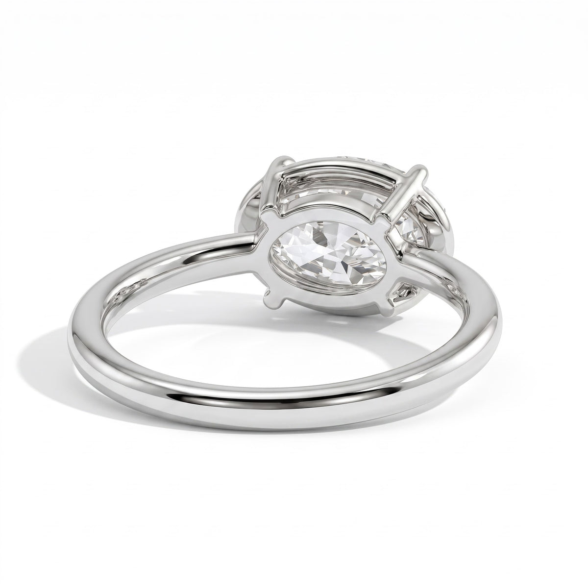 Oval lab-grown diamond bezel-set east-west solitaire engagement ring in 18K (750) white gold, on white background 