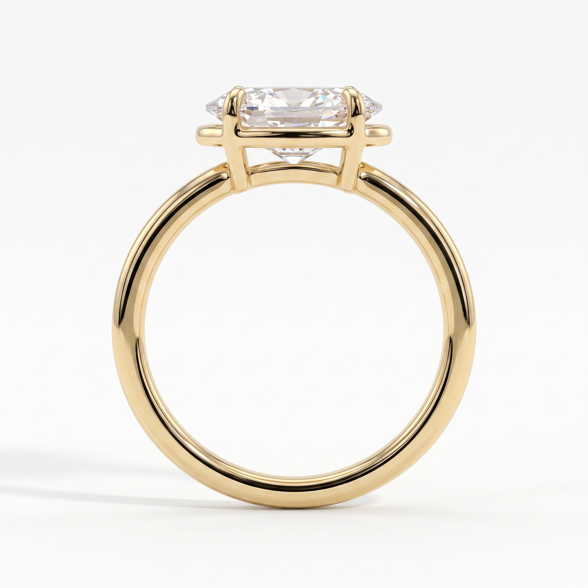 Oval lab-grown diamond bezel-set east-west solitaire engagement ring in 18K (750) yellow gold, side profile 