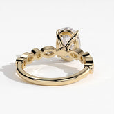 Oval lab-grown diamond bezel-set halo engagement ring in 18K (750) yellow gold, on white background 