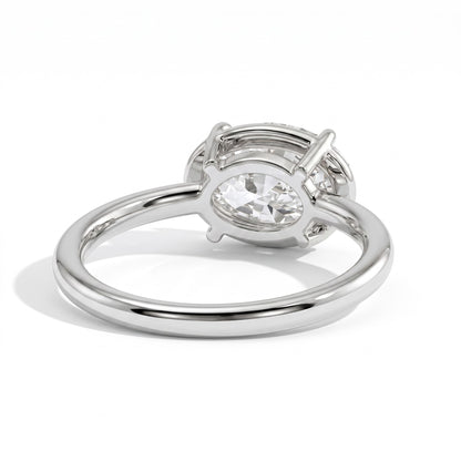 Oval lab-grown diamond bezel-set east-west solitaire engagement ring in 950 platinum, on white background 