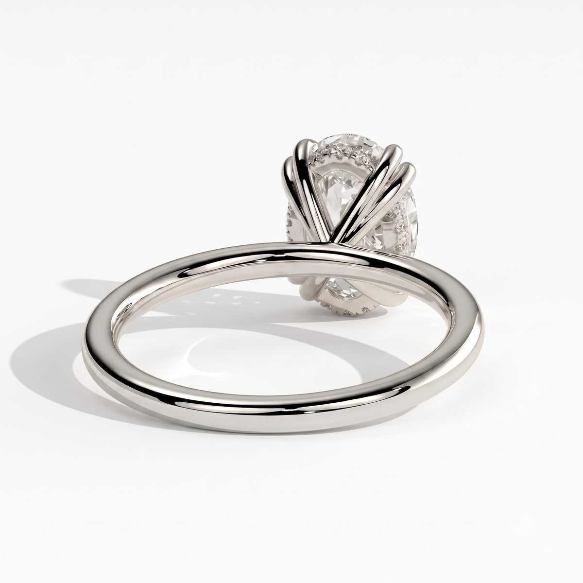 Oval lab-grown diamond halo engagement ring in 950 platinum, on white background 