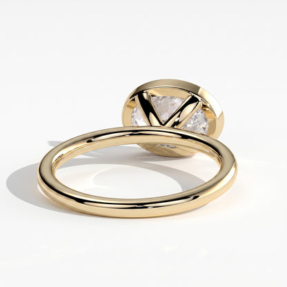 Oval lab-grown diamond bezel-set east-west solitaire engagement ring in 14K (585) yellow gold, on white background 
