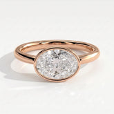 Oval lab-grown diamond bezel-set east-west solitaire engagement ring in 14K (585) rose gold, front view 