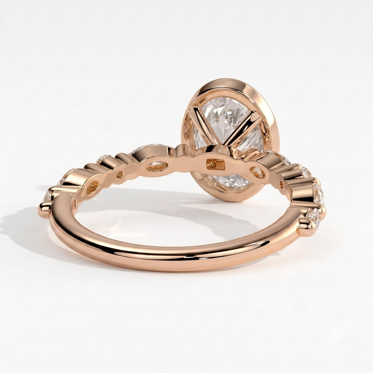 Oval lab-grown diamond bezel-set halo engagement ring in 14K (585) rose gold, on white background 