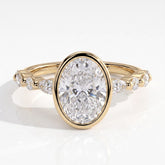 Oval lab-grown diamond bezel-set halo engagement ring in 14K (585) yellow gold, front view 