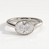 Oval lab-grown diamond bezel-set east-west solitaire engagement ring in 14K (585) white gold, front view 