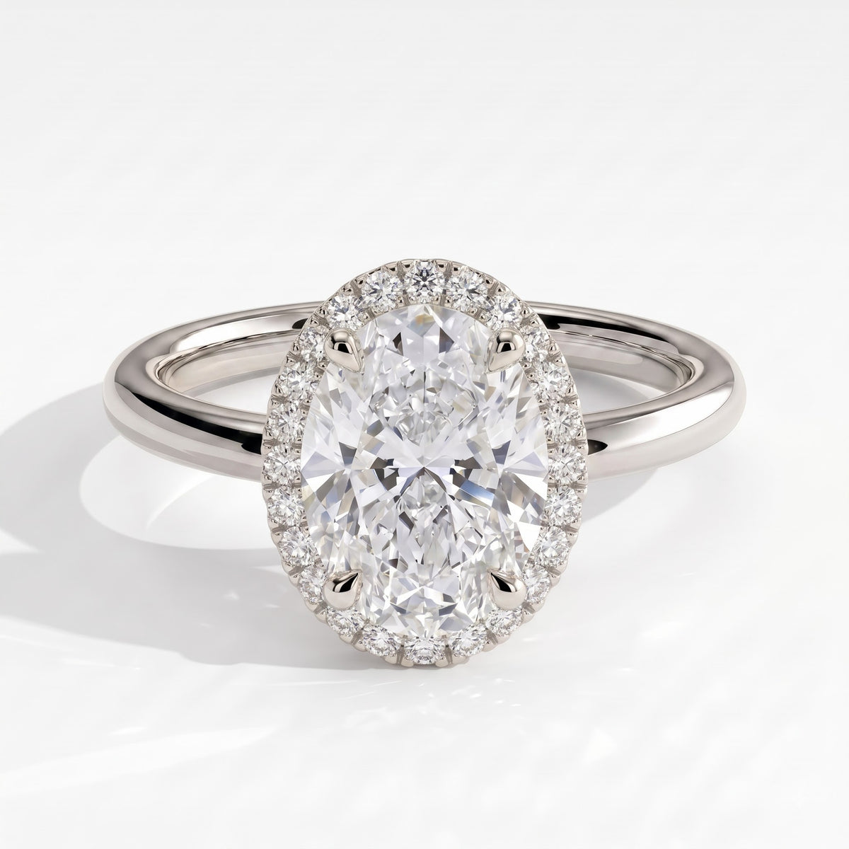 Oval lab-grown diamond halo engagement ring in 18K (750) white gold, front view 
