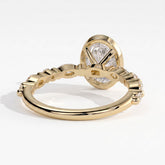 Oval lab-grown diamond bezel-set halo engagement ring in 18K (750) yellow gold, on white background 