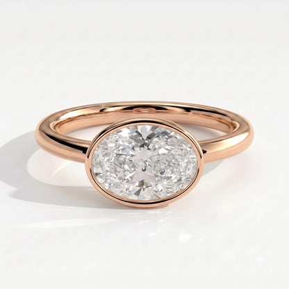Oval lab-grown diamond bezel-set east-west solitaire engagement ring in 18K (750) rose gold, front view 