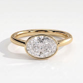 Oval lab-grown diamond bezel-set east-west solitaire engagement ring in 18K (750) yellow gold, front view 