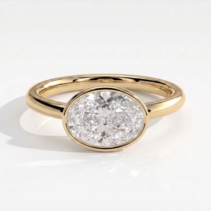 Oval lab-grown diamond bezel-set east-west solitaire engagement ring in 18K (750) yellow gold, front view 