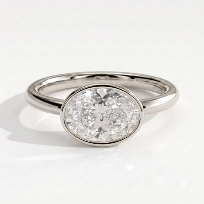 Oval lab-grown diamond bezel-set east-west solitaire engagement ring in 950 platinum, front view 