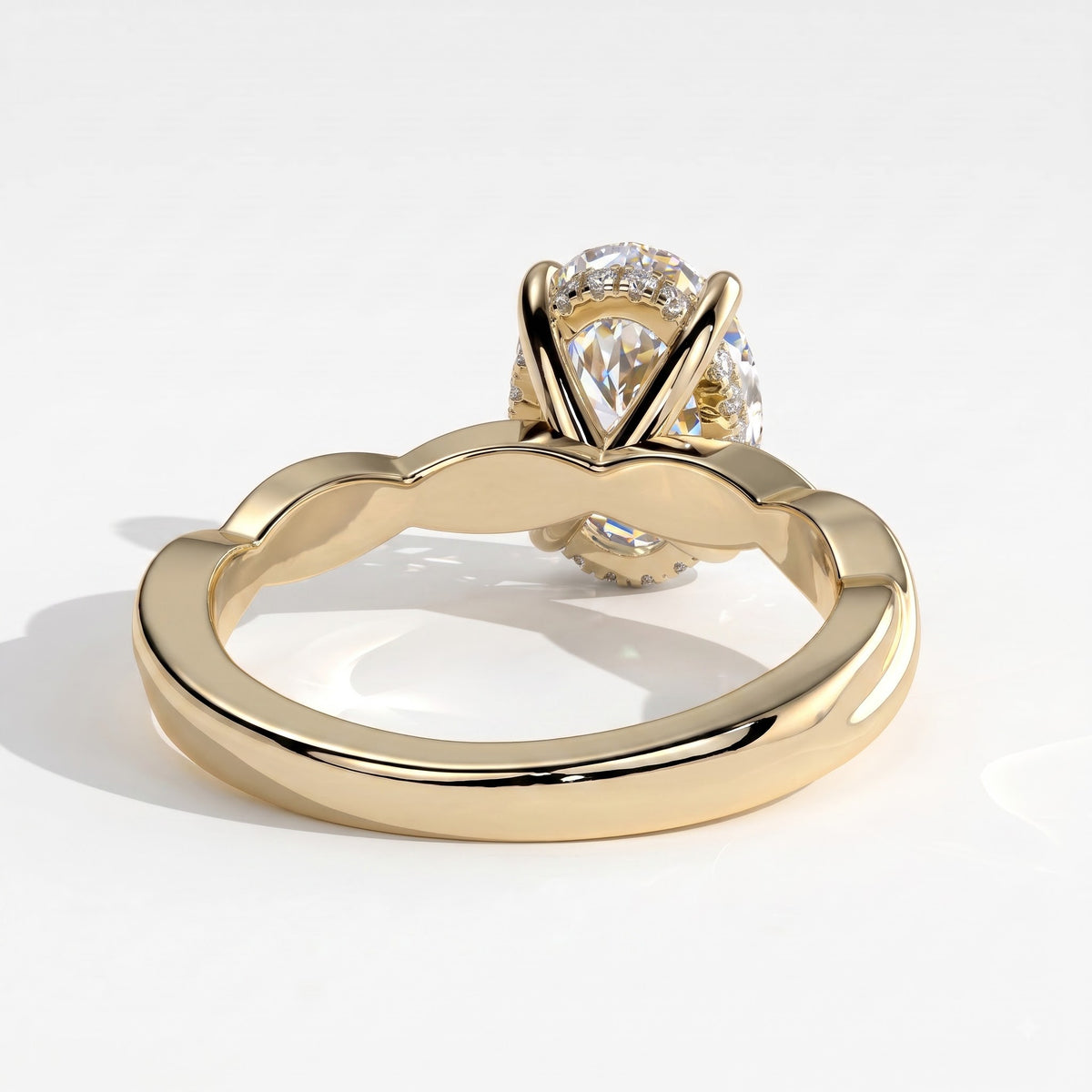 Oval lab-grown diamond solitaire engagement ring in 14K (585) yellow gold, on white background 