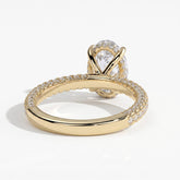 Oval lab-grown diamond halo engagement ring in 14K (585) yellow gold, on white background 