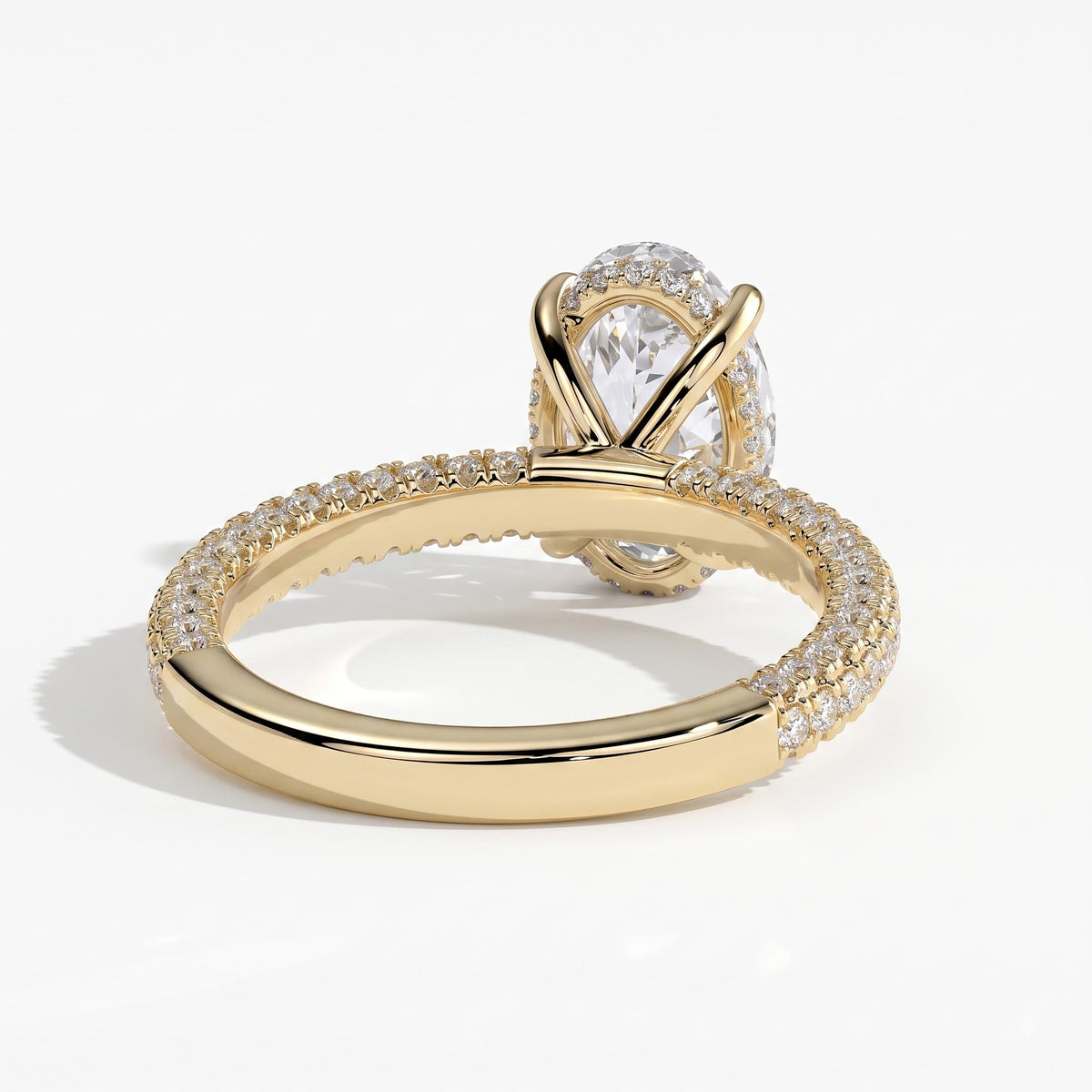 Oval lab-grown diamond halo engagement ring in 14K (585) yellow gold, on white background 
