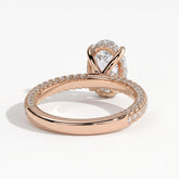 Oval lab-grown diamond halo engagement ring in 18K (750) rose gold, on white background 