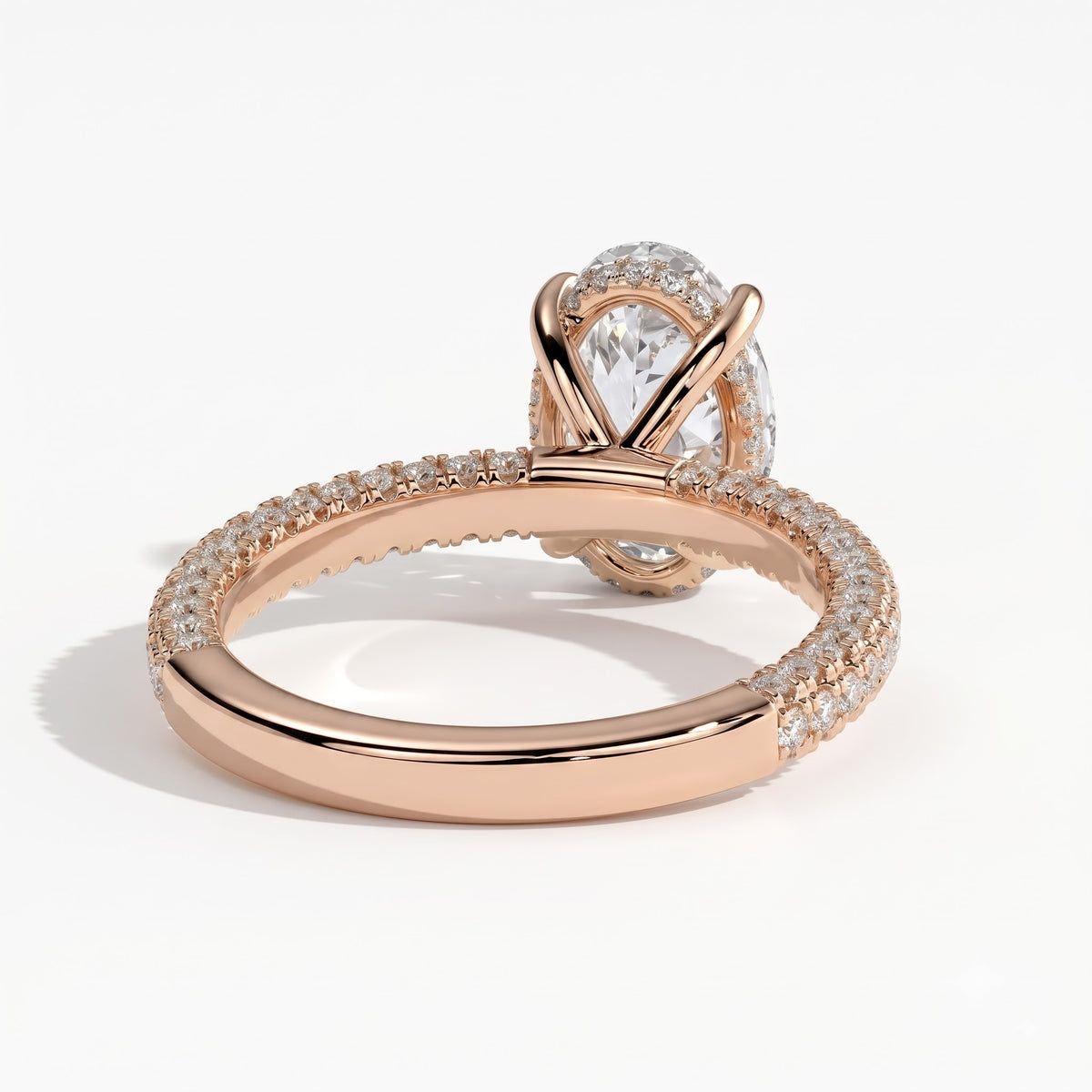 Oval lab-grown diamond halo engagement ring in 18K (750) rose gold, on white background 