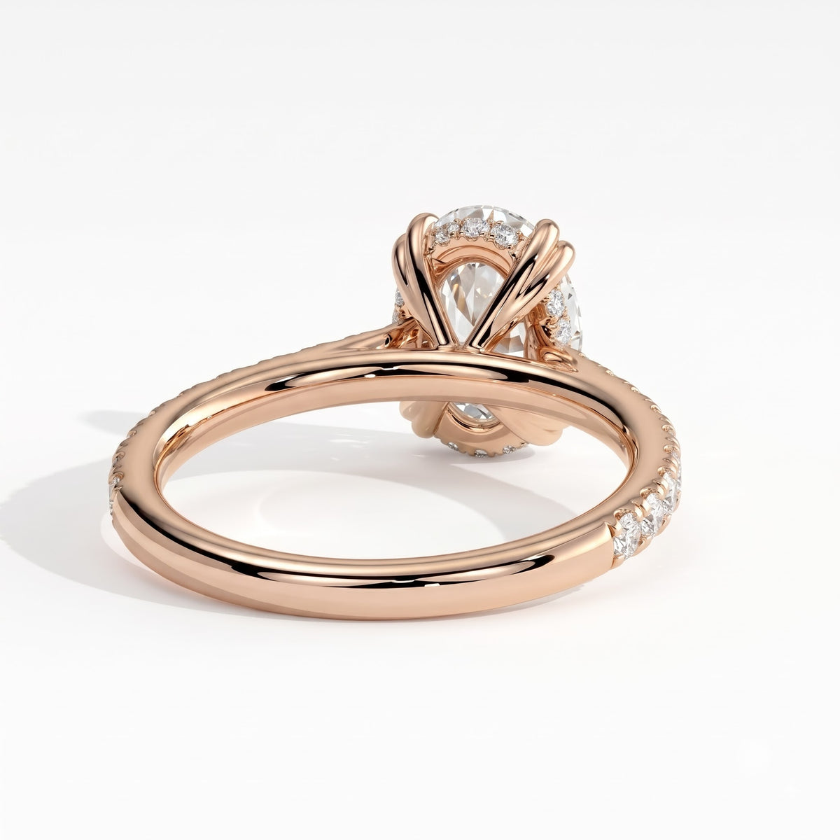 Oval lab-grown diamond halo engagement ring in 18K (750) rose gold, on white background 