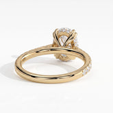 Oval lab-grown diamond halo engagement ring in 18K (750) yellow gold, on white background 