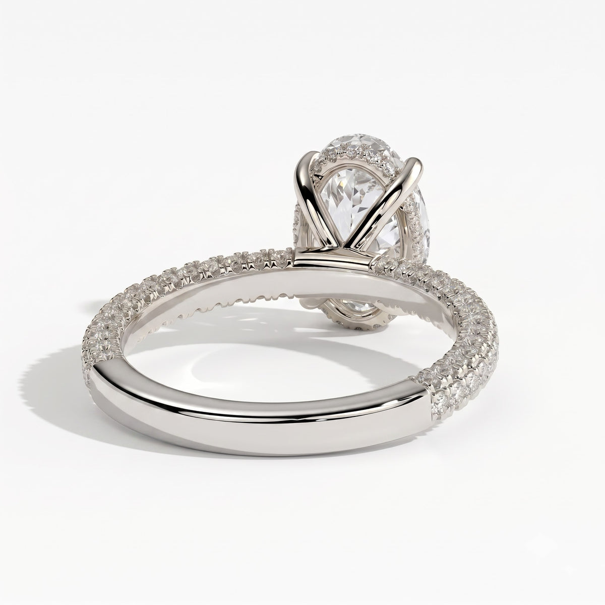 Oval lab-grown diamond halo engagement ring in 950 platinum, on white background 