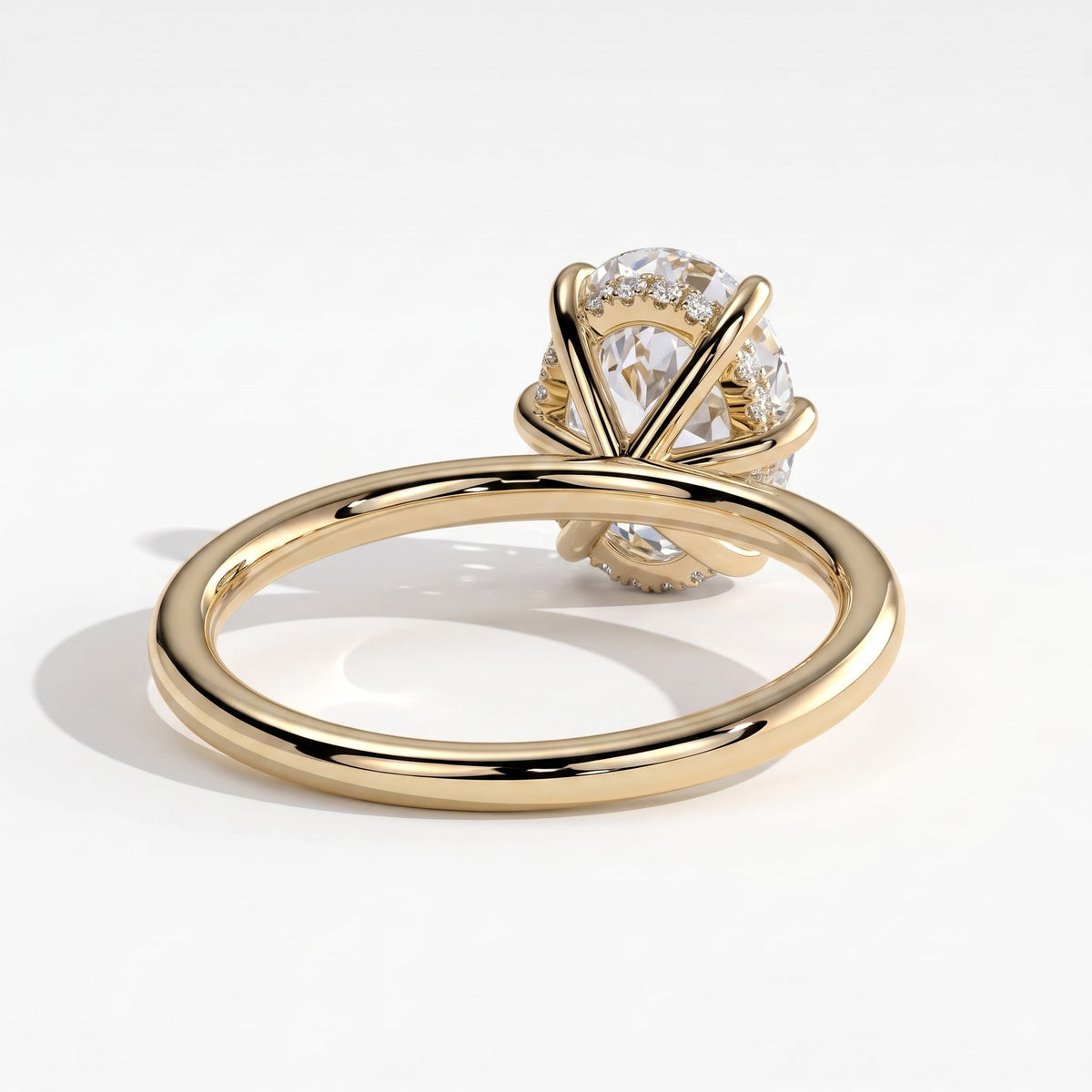 Oval lab-grown diamond solitaire engagement ring in 14K (585) yellow gold, on white background 